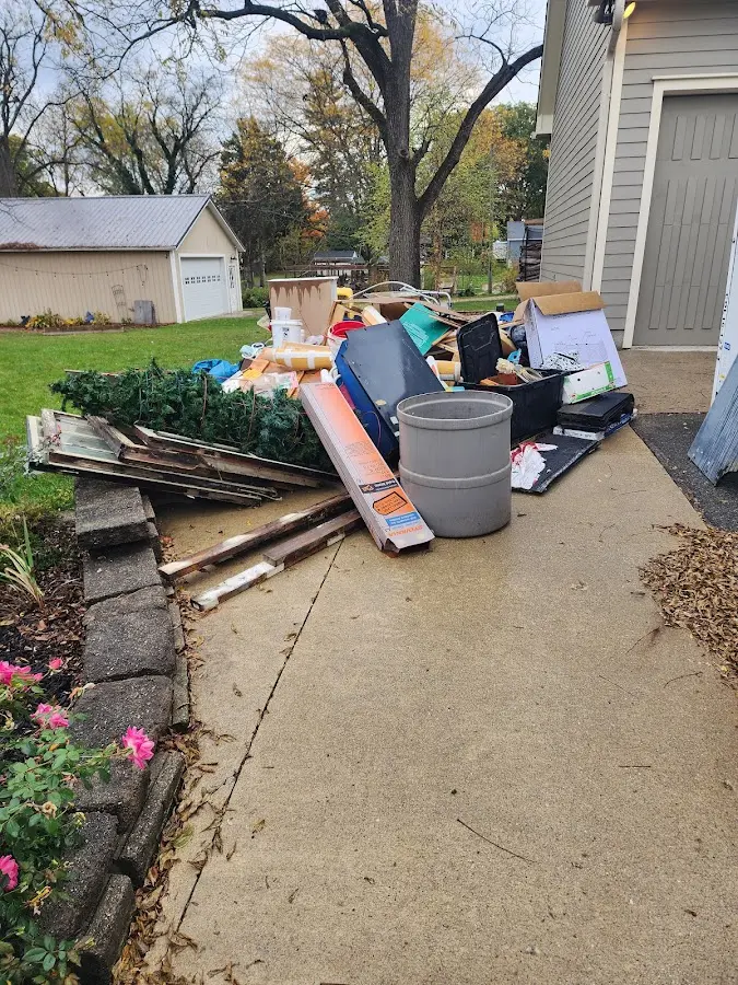 Dumpster being loaded with debris for Commercial Dumpster Rental in Rochester Hills